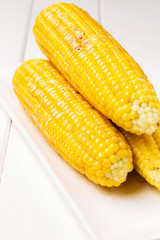 Grilled corn with salt and butter, vertical, selective focus