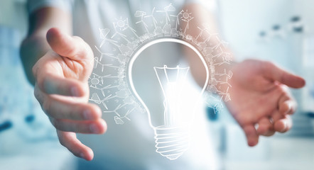 Businessman holding renewable eco lightbulb sketch