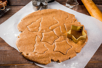 Christmas baking. Ginger dough for gingerbread, gingerbread men, stars, Christmas trees, rolling...