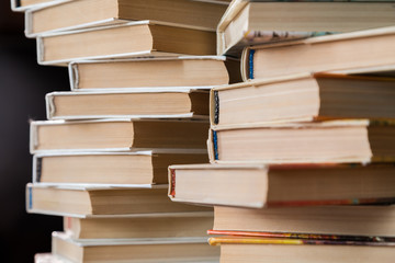 A stack of books in multicolored covers in the library or bookstore.