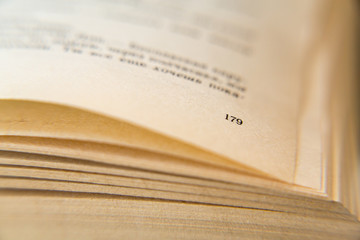 Obraz premium Open old book. Yellowed pages. Page number 179. Paper texture. Macro.