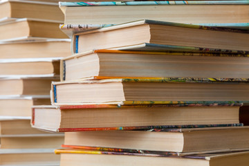 A stack of books in multicolored covers in the library or bookstore.
