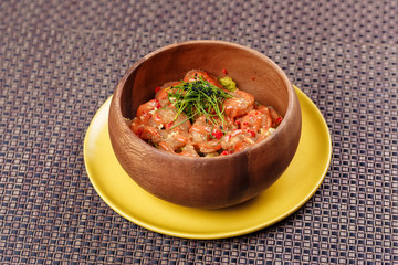 Fried crispy shrimp with leaves of greenery in the bowl