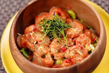 Fried crispy shrimp with leaves of greenery in the bowl