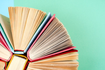 Top view of bright colorful hardback books in a circle.