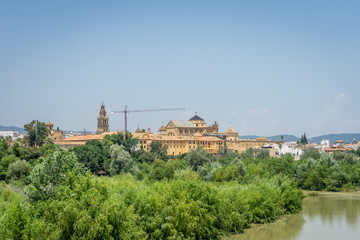 Fototapeta na wymiar The Cathedral mosque and bell tower of Cordoba from the bridge on the river Guadalquivir
