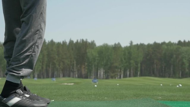 pro golf player shot ball from sand bunker at course. Section of man playing golf in golf course. Golfers hit sweeping golf course in the summer