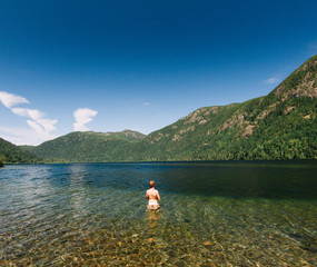 Man standing in the lake under clear sky