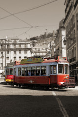 Fototapeta na wymiar Red Trams circulating in Lisbon, Portugal