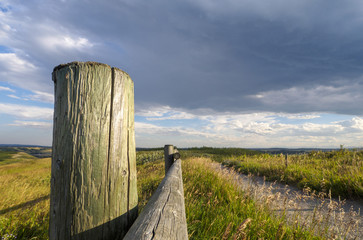 Wooden fence in the prairies on a ranch on a rainy day