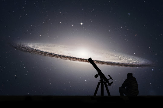 Man with telescope looking at the stars. Sombrero Galaxy M104  in constellation Virgo.