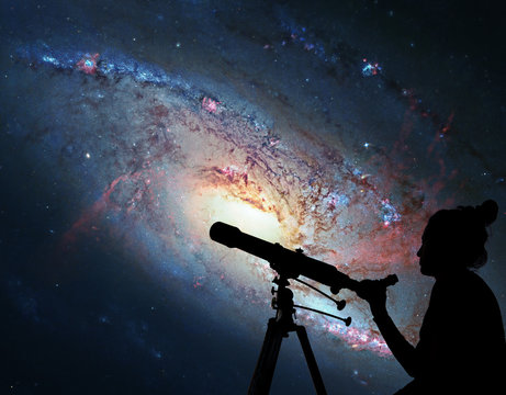 Girl looking at the stars with telescope. Spiral Galaxy M106, in the constellation Canes Venatici. 
