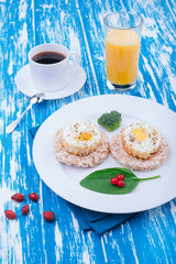 Fried eggs for breakfast. English breakfast. Morning coffee and juice. Wooden board rustic
