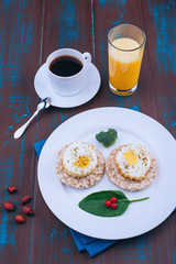 Fried eggs for breakfast. English breakfast. Morning coffee and juice. Wooden board rustic