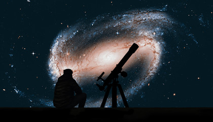 Man with telescope looking at the stars. Spiral galaxy in the constellation Eridanus NGC 1300 