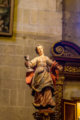 Sculpture of a lady holding a chalice inside the Mosque Church of Cordoba, Spain, Europe