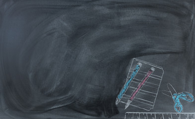 Back to school hand drawn materials on erased chalkboard