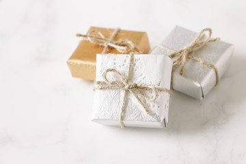 gold and silver gift on white stone table