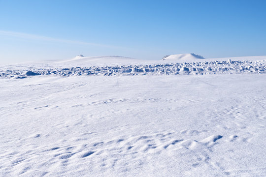 Altai plain winter landscape with snow field under blue sky