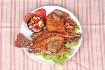 Deep fried Tilapia with spicy and sour herb salad .