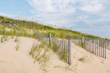 A staircase leading to the beach with sand fences in Nags Head, North Carolina.  