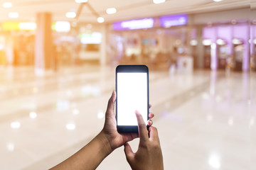 Hands holding blank white screen smart phone in front of the bank, Hands holding blank white screen smart phone to use for financial transactions. Concept : pay, financial.