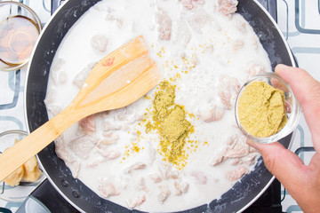 Chef putting green curry powder for cooking