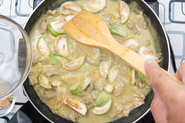 Chef putting Thai Brinjal for cooking green curry