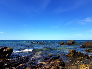 Beach and blue sky / A beach is a land along a body of water. It usually consists of loose particles, which are often composed of rock, such as sand, gravel, shingle, pebbles