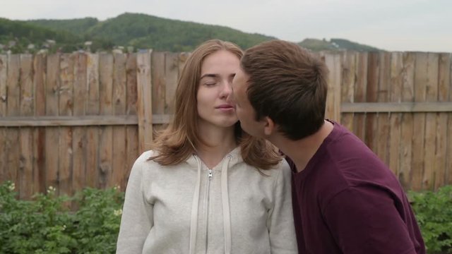 Man kissing his girlfriend in the garden