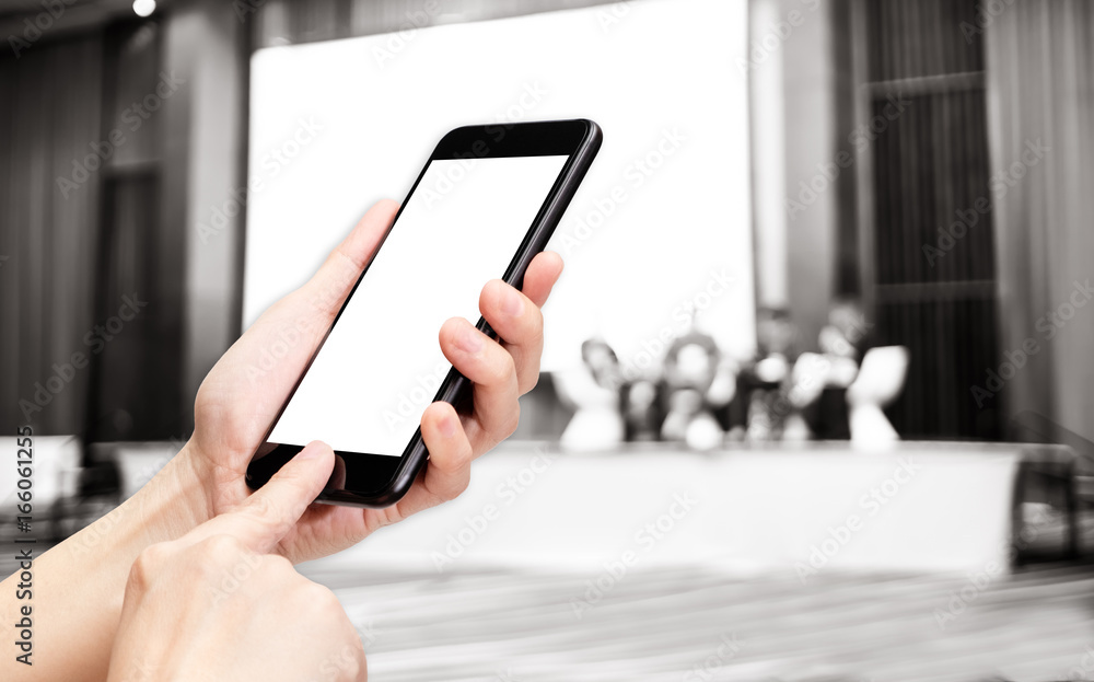 Aufkleber Hand click mobile phone with blur people seminar on stage at convention hall with bokeh light,White screen mock up template for adding your design or your text