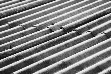 Repeating pattern of an asbestos sheet in monochrome style.