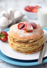 freshly prepared pancakes with strawberries