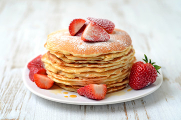 freshly prepared pancakes with strawberries