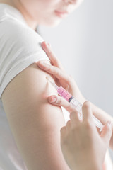 Fototapeta premium Injections on the upper arm.