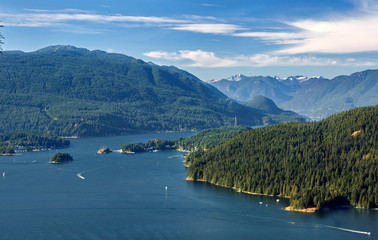 Vancouver Harbor and Indian Arm on the background scenery of snow-capped mountains and blue water.