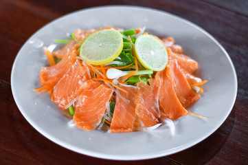 Fresh salmon with vegetable, lemon and sauce