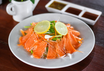 Fresh salmon with vegetable, lemon and sauce