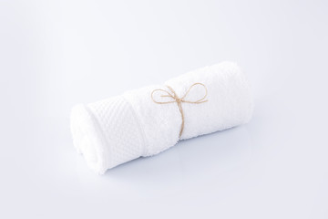 White towel and herbal balls on a white background