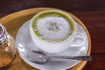 Hot matcha green tea latte glass with milk