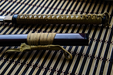 Japanese sword katana on bamboo mat