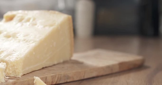 slide pieces of hard parmesan cheese on olive board