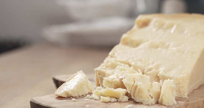 slide pieces of hard parmesan cheese on olive board
