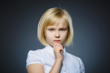 Closeup Thoughtful girl with Hand at head isolated on Gray