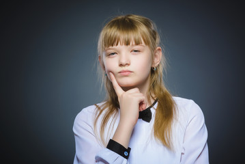 Closeup Thoughtful girl with Hand at head isolated on Gray
