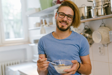 Man eating healthy breakfast in his kitchen