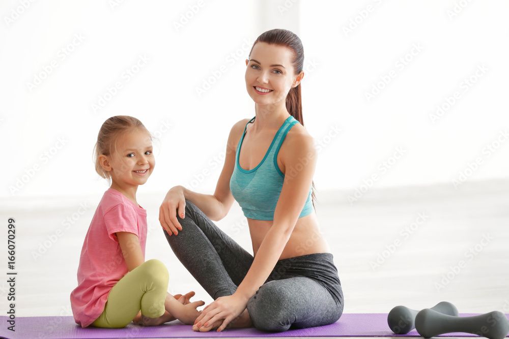 Sticker Mother and daughter sitting in gym