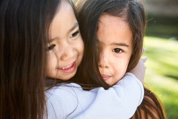 Cute little girls hugging. Sisters and best friends.