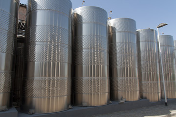 Metal chrome cask for wine photo. Stainless steel pipes and barrels as part of winery equipment