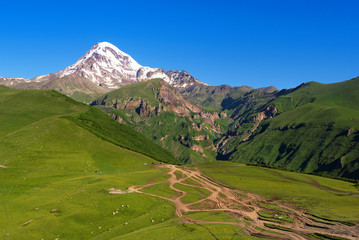 Mount Kazbek (5033 meters) view from Stepantsminda town in Georgia in good weather for climbing. It...